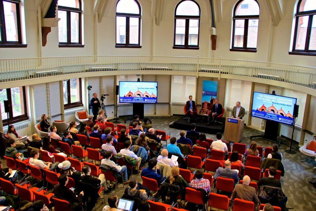 A full room of people listening to a lecture