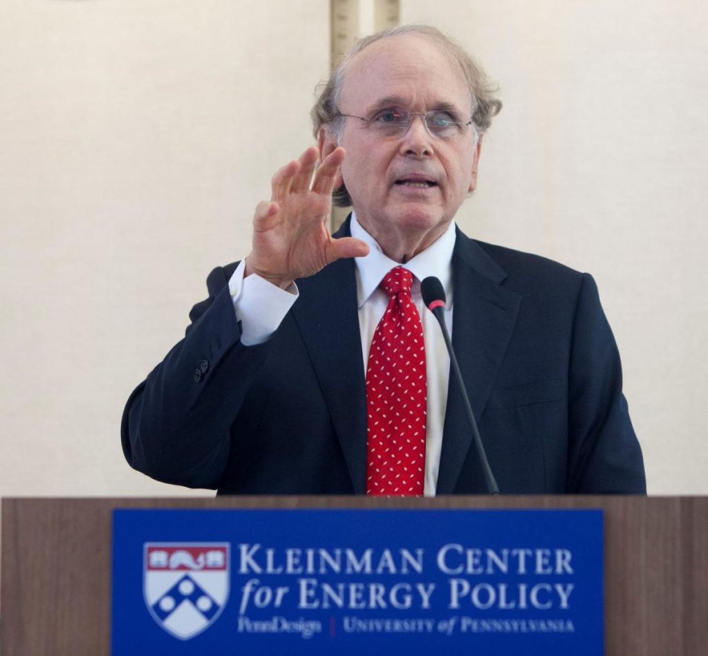 Man speaks at a podium in front of "Kleinman Center for Energy Policy" sign