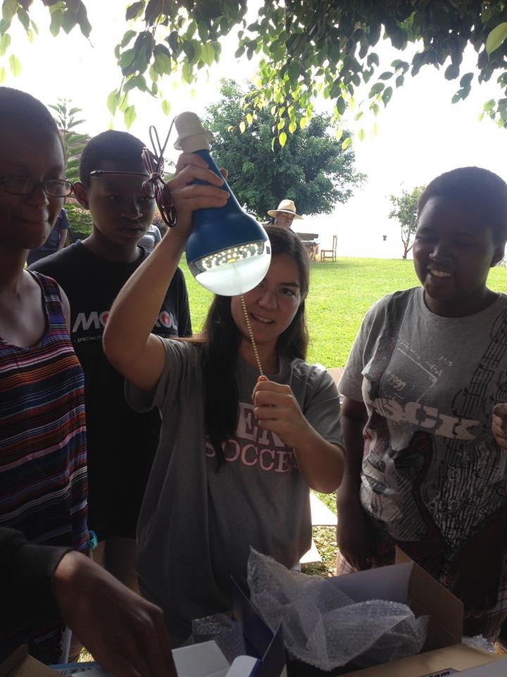 Students take turns trying a lightbulb