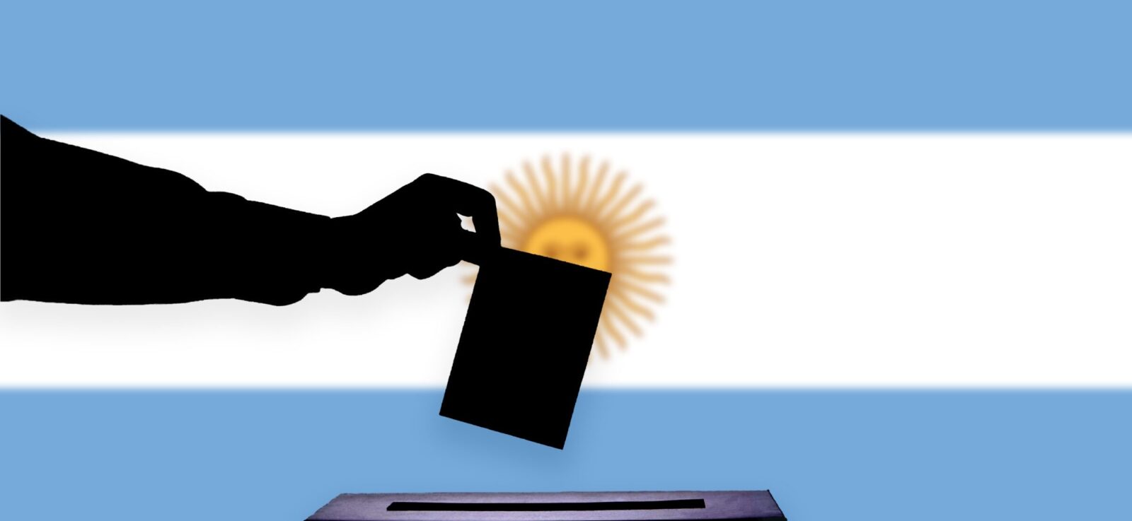 A ballot is placed into a box in front of the Argentinian flag