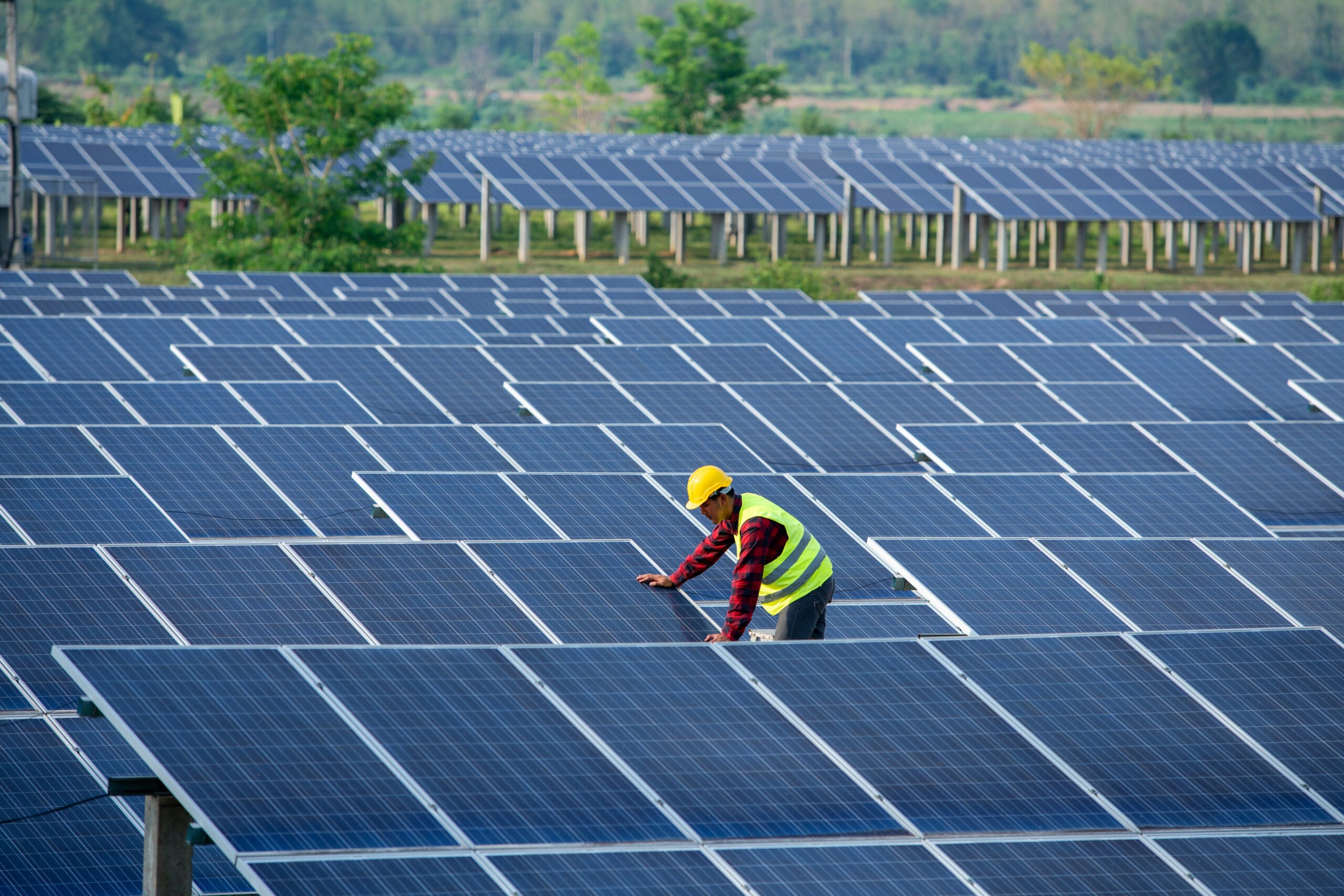 Engineers or operators are checking the solar panel.