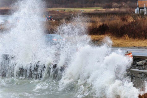 Powerful waves crash against retaining wall along Ocean Drive in Newport, Rhode Island